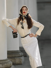 a lady wears a beige shirt with white pencil skirt